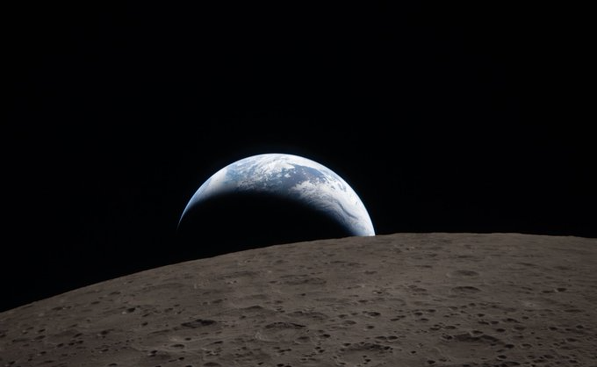La Terra emergint darrere l'horitzó polsegós de la Lluna, captada des de la nau Orion durant la missió Artemis 2.